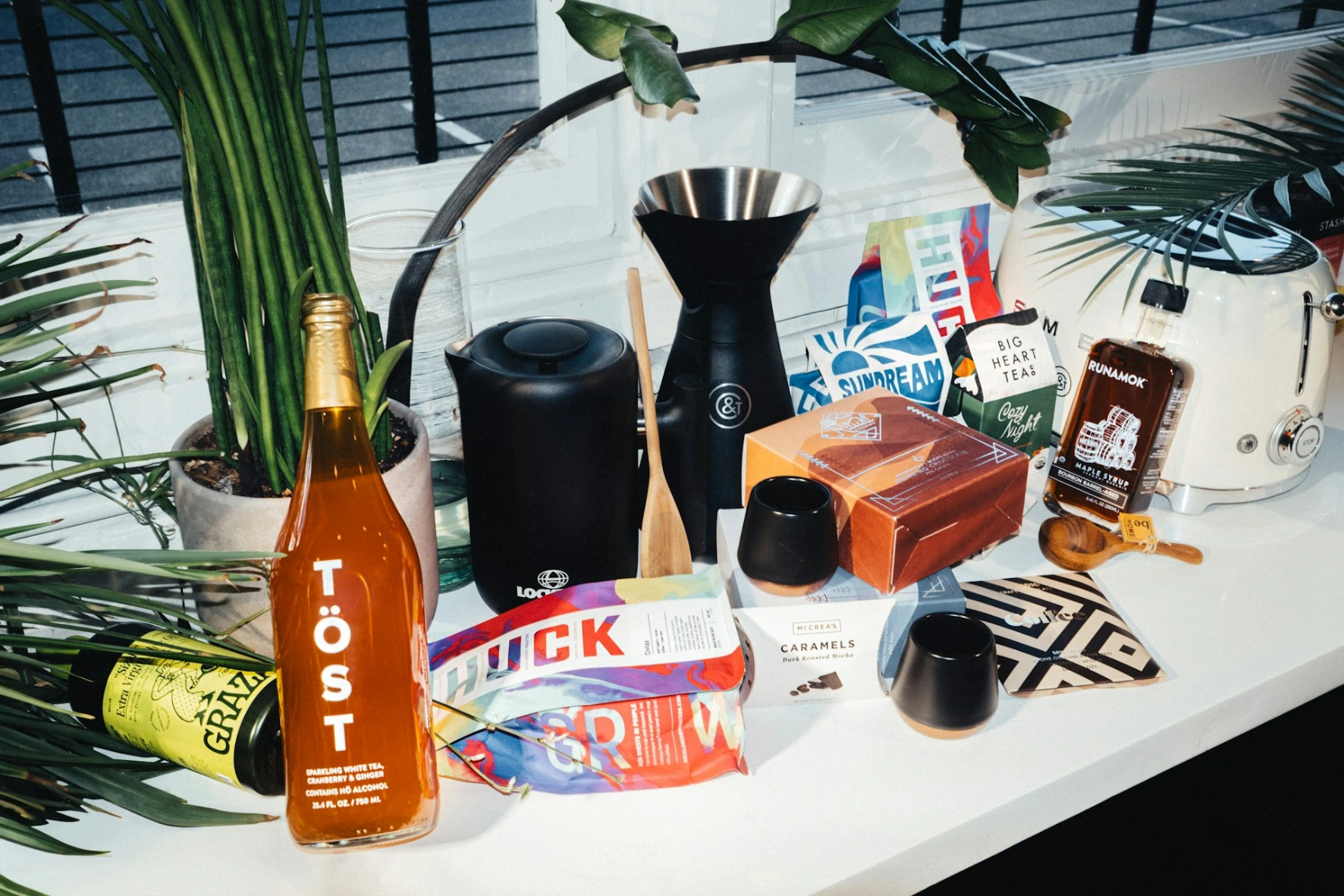 Various products and plants arranged on a shelf.